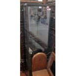 A 16 3/4" modern glazed pedestal display cabinet with three glass shelves and locking door with