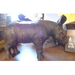 A bronzed resin rhino calf - indistinctly signed to underside