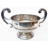 An 8" diameter silver pedestal trophy cup "Carbine Shooting Cup" with flanking open scroll handle (