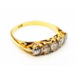 A marked 18ct. five stone old cut diamond ring