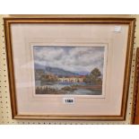 Wilfrid Ball: a gilt framed watercolour, depicting a river with town and bridge in distance - signed
