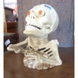 An iron skeleton money box