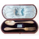 A Victorian leather clad cased part christening set with ornate spoon and fork - napkin ring