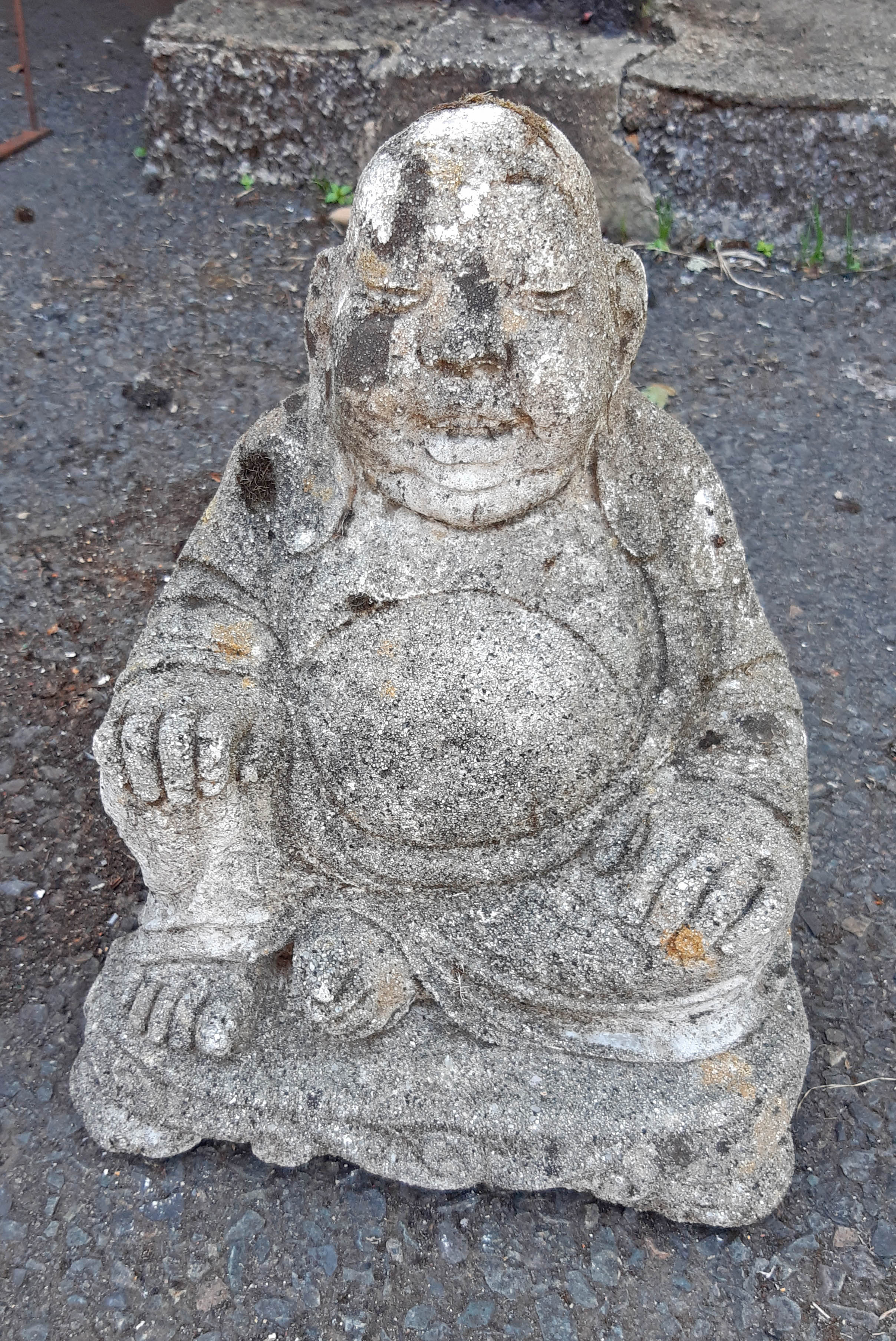 A concrete garden Buddha statue