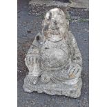 A concrete garden Buddha statue