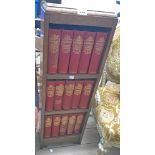 A small polished oak three shelf open bookcase containing fifteen vols. The Works of Charles Dickens