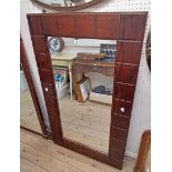 A modern stained wood framed oblong wall mirror with moulded block border - 4' 3" X 30 1/2"