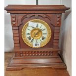 A late 19th Century stained oak cased American shelf clock with decorative dial, bezel and Ansonia