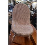 A Lloyd Loom curved back bedroom chair with original label and pink sprayed finish - some wear