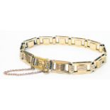 A marked 15ct yellow metal fancy link bracelet with safety chain