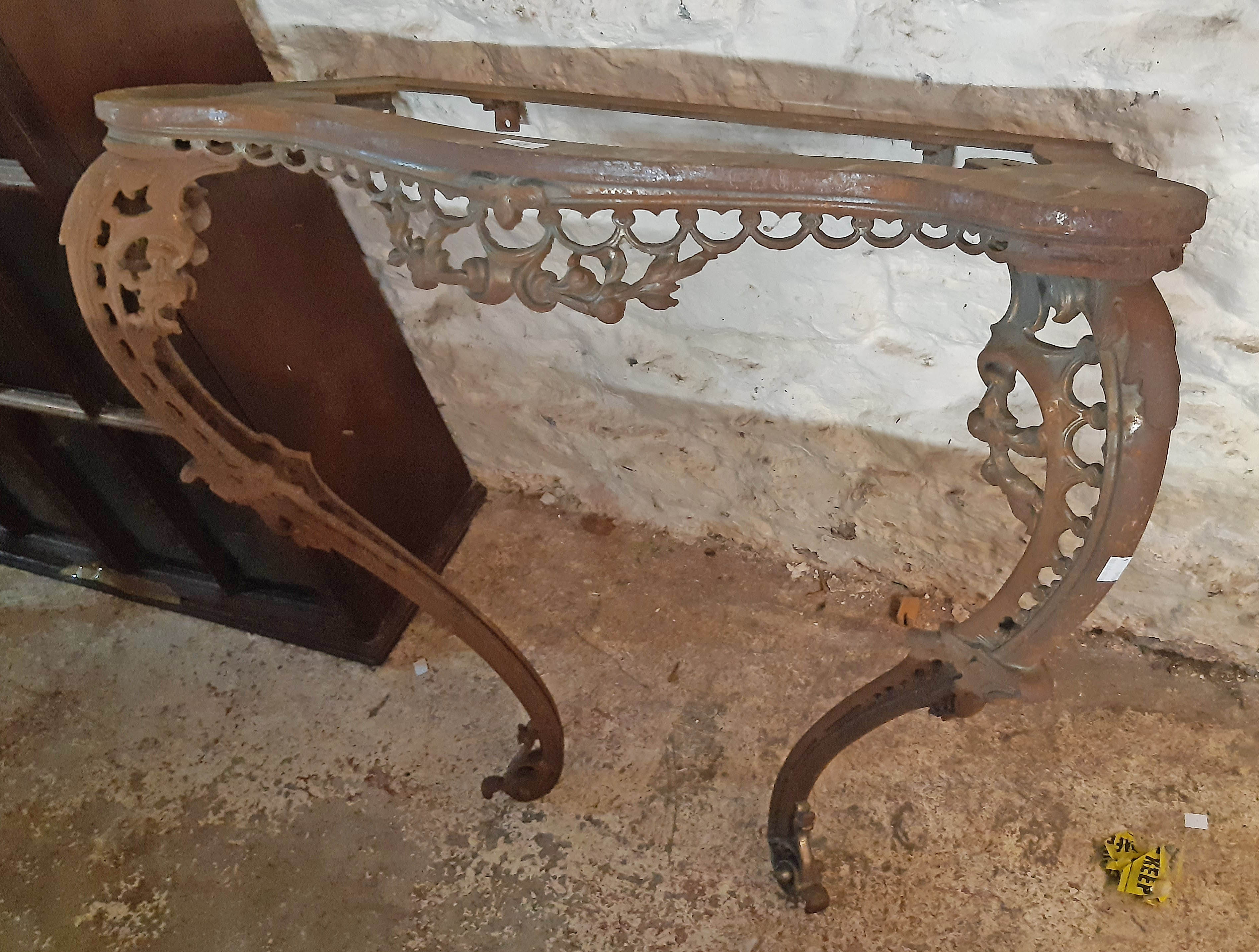 A mid 19th Century fine cast iron console table base of serpentine design with fruit swags and