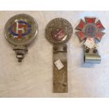 Three car badges comprising Touring Club de France, Order of the Road 60 Year Driver, and The