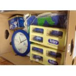 A box containing assorted Tetley collectables including die cast vehicles, caricature sets, clock,