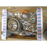 A box containing a quantity of silver plated items including cutlery, two pairs of candlesticks,