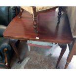 A 4' 11 1/2" stained wood draw-leaf dining table, set on cabriole legs with pad feet - top