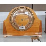 A vintage Bentima polished walnut and mixed wood cased mantel clock with eight day chiming movement