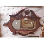 A 30" Edwardian mahogany framed wall mirror with shaped plate and shelf to front