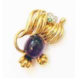 A hallmarked 18ct. gold stylised dog pattern brooch, set with large amethyst cabochon, small