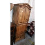 A 31 1/2" antiqued pine break dome top single wardrobe with pull-out hanging rail, removable shelves