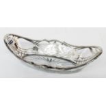A 11 1/4" glass elliptical dish with star cut base and white metal cage work featuring lattice and