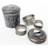 A silver dressing table pot with push fit lid, C-scrolls and floral decoration - sold with three