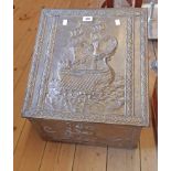 A 20th Century brass clad slope fronted coal box with embossed galleon decoration