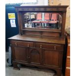A 5' 1/2" early 20th Century polished oak mirror backed sideboard with domed mirror plate and