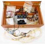 A leather case containing vintage and other costume jewellery