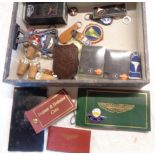 A box containing various items of automobilia including Mercedes Benz keyrings and bottle corks,
