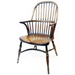 A high quality reproduction solid elm Windsor elbow chair with thick solid moulded seat, set on