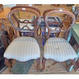 A set of four Victorian mahogany framed balloon back standard chairs with over stuffed upholstered