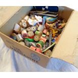 A vintage Stork margarine packing box containing a large quantity of vintage sewing threads and