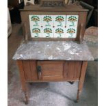 A 33" Edwardian satin walnut and marble topped washstand with tile set raised splash back and
