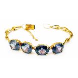 A marked 14K yellow metal fancy link bracelet set with four large oval alexandrite stones with