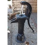 A reproduction painted cast iron garden pump