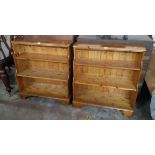 A pair of 3' 2" Ducal polished pine three shelf open waterfall bookcases with moulded decoration,