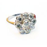 A marked PLAT white metal flowerhead pattern ring, set with nine brilliant cut diamonds - 1.65ct.