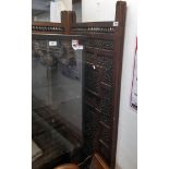 An old carved Eastern hardwood four fold screen decorated with inset fretwork foliate scroll panels,