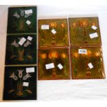 Four Art Nouveau tiles depicting stylized triple flower heads - sold with three tiles with