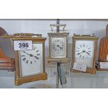 Two brass and bevelled glass carriage timepieces both with keys - various condition - sold with a