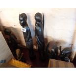 Five African carved wood figures including a pair and a bust - sold with a stone carving (damaged)