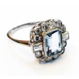 A marked PLAT white metal ring, set with central oblong aquamarine within a brilliant cut diamond