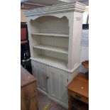 A 3' 10" antique style painted pine dresser with moulded cornice and three open shelves over pair of