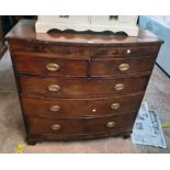 A 4' 7 1/4" early 19th Century mahogany and cross banded bow front chest of two short and three long