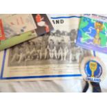 A 1966 England World Cup rosette, team poster (folded and rolled), souvenir Evening Standard, and