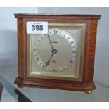 A vintage polished oak cased mantel timepiece with canted front corners, dial marked for J. Ness,