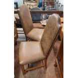 A pair of late 20th Century high back standard chairs with faded and studded brown leather