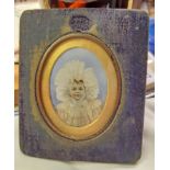 A blue velvet clad framed 2 1/2" Victorian portrait miniature on ivory, depicting a baby wearing a