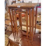 A nest of three Edwardian mahogany and strung tea tables, set on square supports with ring turned