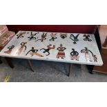 A 3' 11" 1960`s African peitra dura specimen marble topped coffee table with two rows of male and